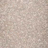 A soft stone surface with a granular mix of pink, beige, and gray.