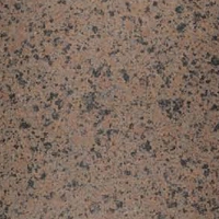 Speckled soft stone surface with light brown and dark speckles.