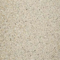 Close-up view of a light beige, textured soft stone surface with specks of brown and gray.