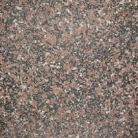 Close-up of a speckled stone surface with pink, black, gray, and white mineral grains.