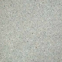 Close-up of a speckled soft stone surface with gray and black particles.