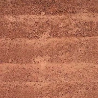 Textured reddish-brown soft stone surface with horizontal layers.