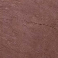 Close-up of a reddish-brown soft stone surface with a subtle crack.