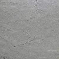 Close-up of a soft stone surface with natural gray and light green tones, featuring subtle lines and patterns.