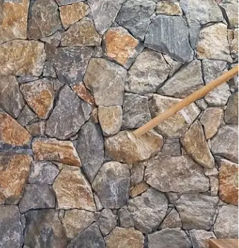 A stone wall with a wooden stick