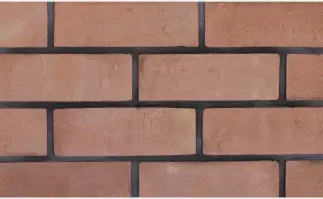 Gray wall with a small hole, up close, featuring of stone pattern.